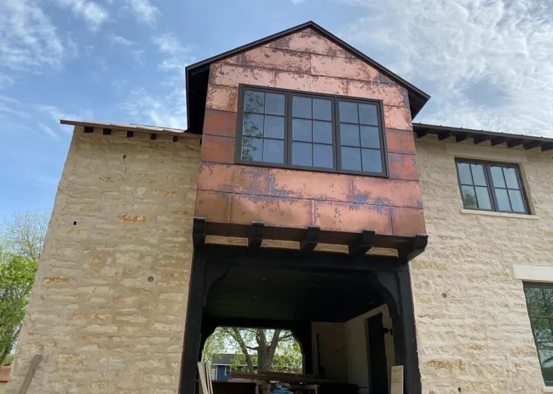 Copper metal panel facade on a stone building for Skylight Installation in Pasadena Hills