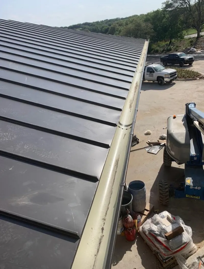 Standing seam panel and gutter detail on a metal roofing jobsite in Pasadena Hills